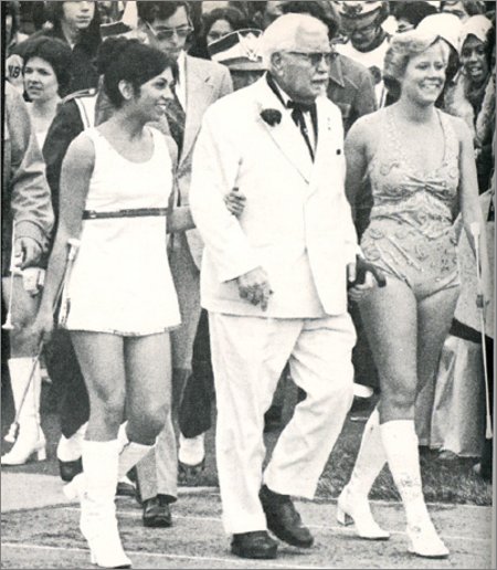 yes, it's colonel sanders with two cheerleaders