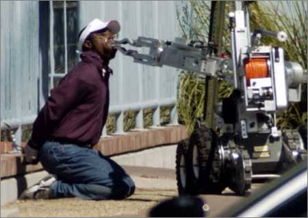 a robot removes tape from a man's mouth